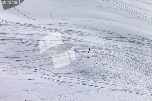 Image of Silhouettes of snowboarders and skiers on off piste slope