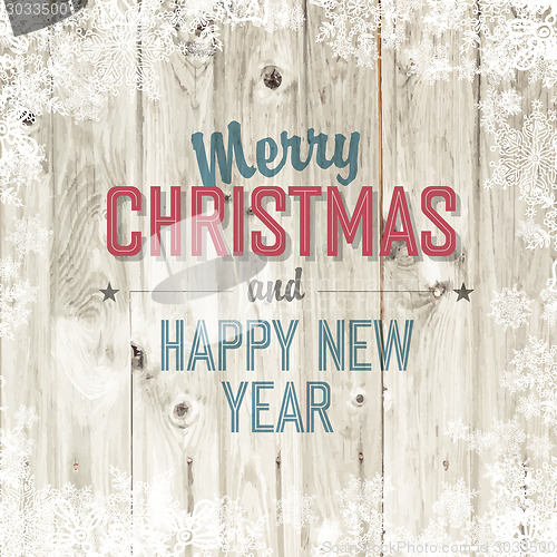Image of Merry Christmas greeting on blond wooden background