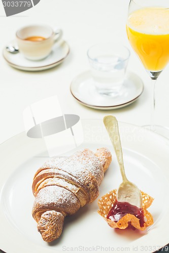 Image of breakfast with croissant,coffee and juice
