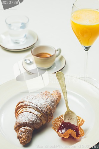 Image of breakfast with croissant,coffee and juice