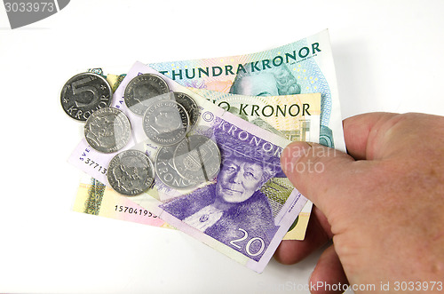 Image of Reaching over swedish money
