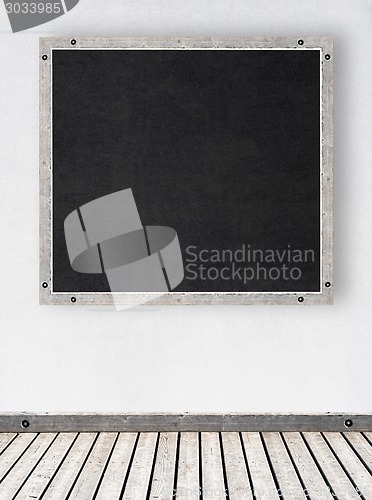 Image of white stucco wall with chalkboard