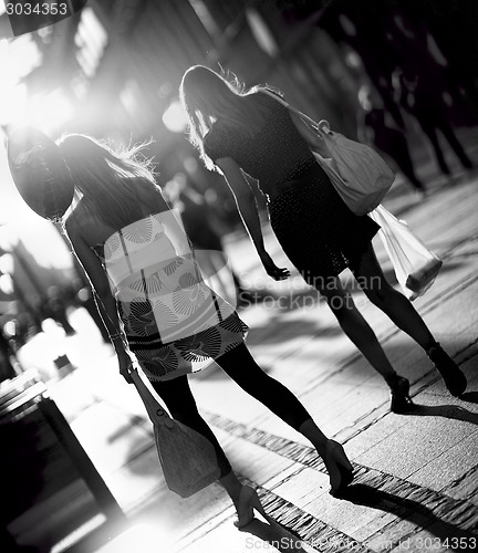 Image of Beautiful women walking down street