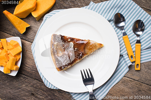 Image of  pieces of pumpkin and pie on plate in Rustic style