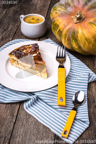 Image of piece of Pumpkin pie with mousse on wood in Rustic style