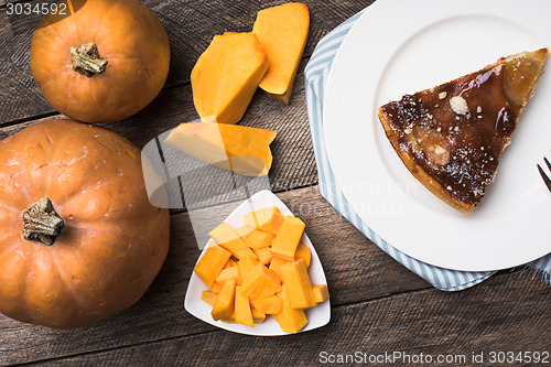 Image of pumpkins and pie on plate on wood  in Rustic style