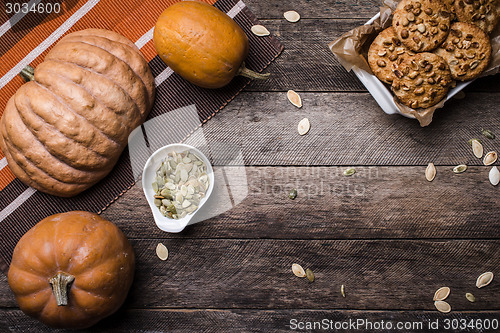 Image of Pumpkins with seeds and  cookies on wood in Rustic style