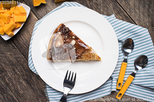 Image of Lunch pie on plate and pieces of pumpkin in Rustic style