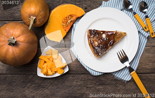 Image of pumpkins and pie on plate in Rustic style