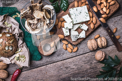 Image of rustic style cheese with bread, cep and nuts