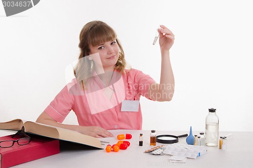 Image of Medical student examines powder in a test tube