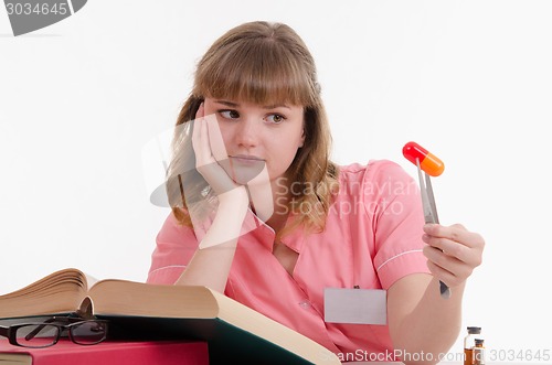 Image of Tired student with a pill