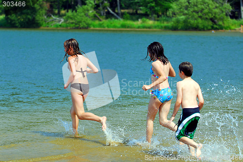 Image of Children running into water