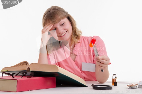 Image of Medical student happily looking at pill