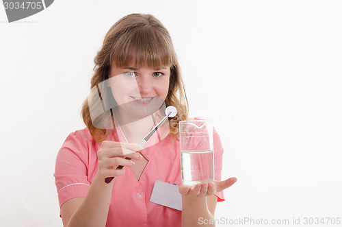 Image of Pharmacist throws pill to liquid water