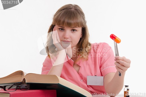 Image of Tired doctor with pill