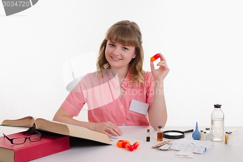 Image of doctor with a big pill in hand