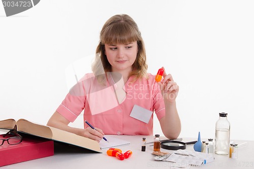 Image of Pharmacist studying composition pills