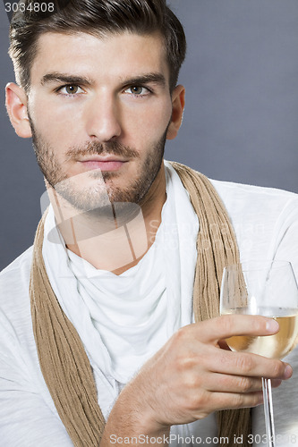 Image of Sexy handsome man drinking white wine