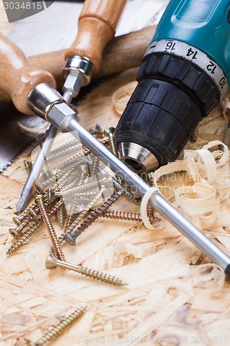 Image of Drill with timber, screwdrivers and screws