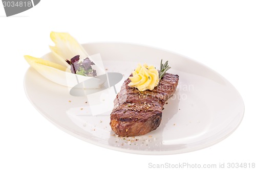 Image of Grilled beef steak topped with butter and rosemary