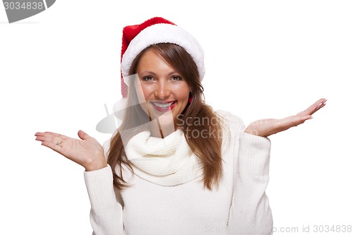 Image of Attractive woman wearing a festive red Santa hat