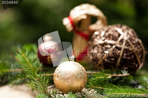 Image of Gold Christmas ornament on leaves