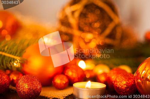 Image of Warm gold and red Christmas candlelight background