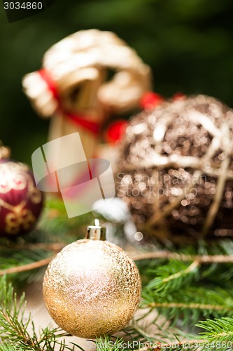 Image of Gold Christmas ornament on leaves