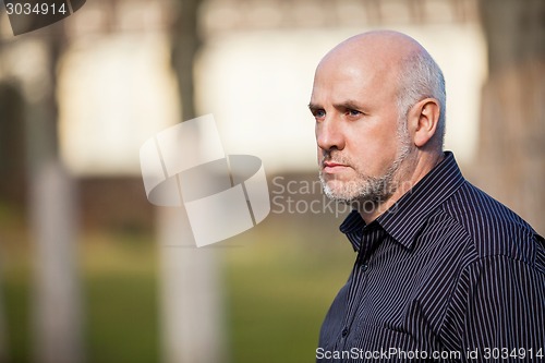 Image of Confident attractive man standing waiting