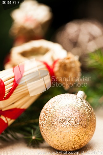 Image of Gold Christmas ornament on leaves