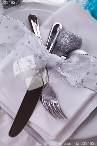 Image of Stylish blue and silver Christmas table setting