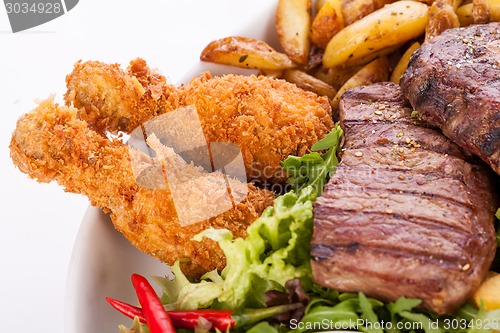 Image of Platter of mixed meats, salad and French fries