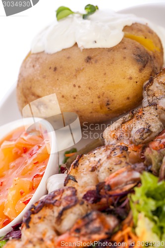 Image of Grilled prawns with endive salad and jacket potato