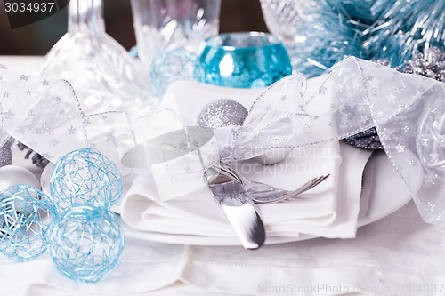 Image of Stylish blue and silver Christmas table setting