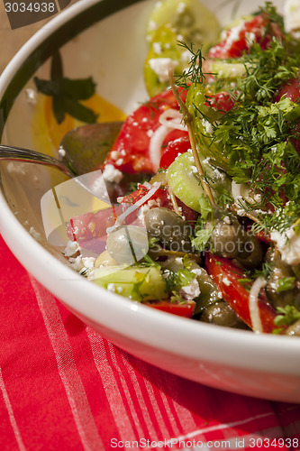 Image of Bowl of Marinated Greek Salad with Red Napkin