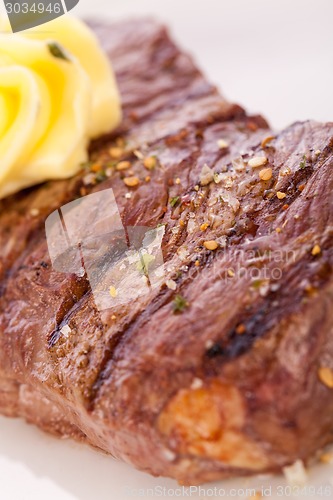 Image of Grilled beef steak topped with butter and rosemary