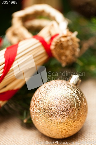 Image of Gold Christmas ornament on leaves