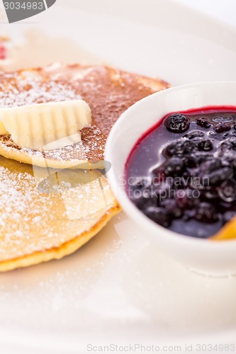 Image of tasty sweet pancakes with vanilla icecream and topping