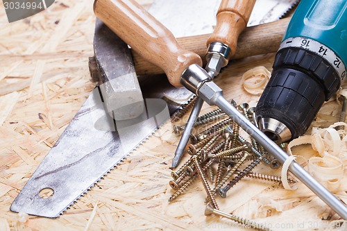 Image of Drill with timber, screwdrivers and screws