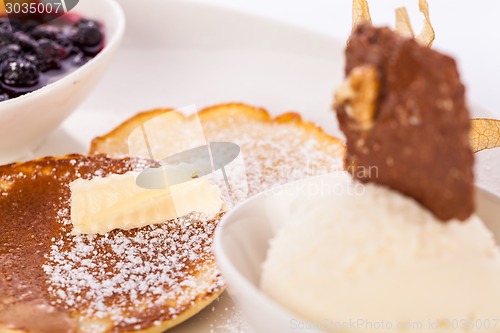 Image of tasty sweet pancakes with vanilla icecream and topping