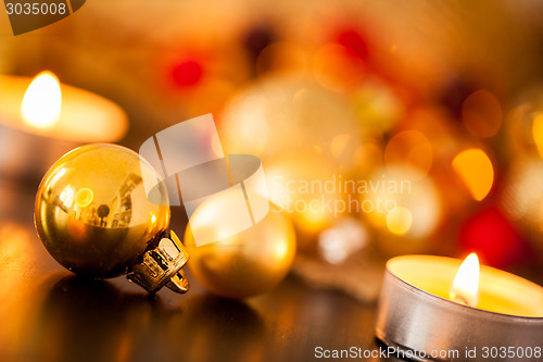 Image of Warm gold and red Christmas candlelight background