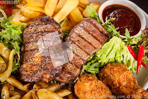 Image of Platter of mixed meats, salad and French fries