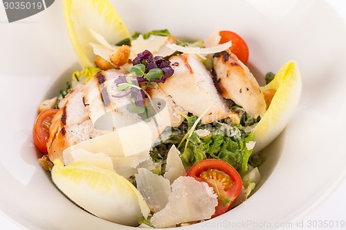 Image of tasty fresh caesar salad with grilled chicken and parmesan 