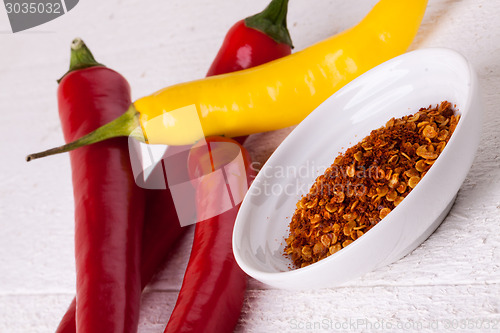 Image of Fresh red and yellow chili peppers with spice