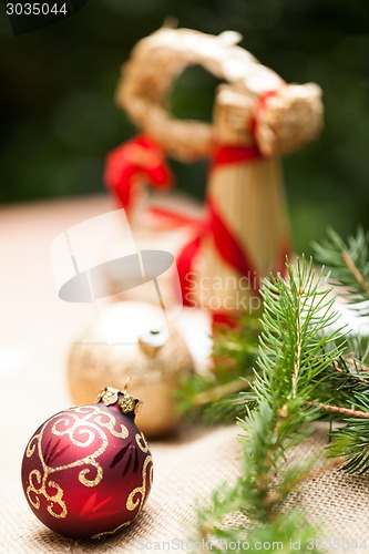 Image of Gold Christmas ornament on leaves