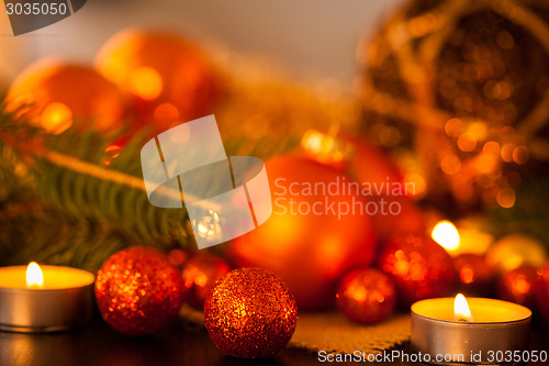 Image of Warm gold and red Christmas candlelight background