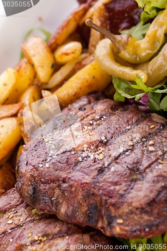 Image of Platter of mixed meats, salad and French fries