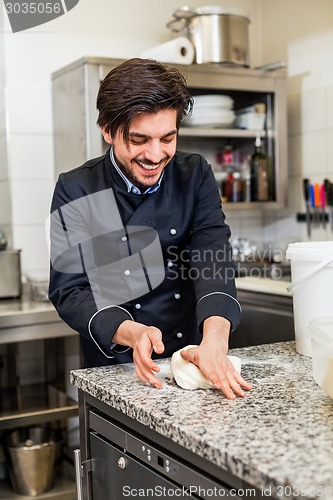 Image of Chef tossing dough while making pastries