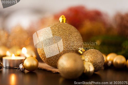 Image of Warm gold and red Christmas candlelight background